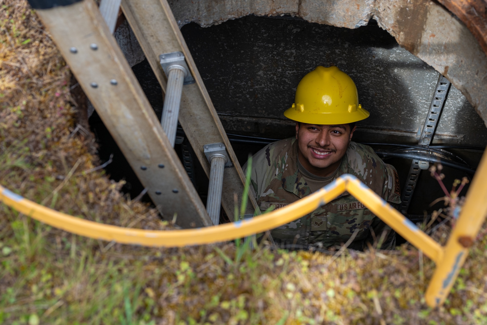 U.S. Air Force Senior Airman Angel Cortez, a cable and antenna systems technician with the 627th Communications Squadron, listens to instruction from a teammate at Joint Base Lewis-McChord, Washington, May 28, 2024. Cable and antenna systems Airmen work closely to ensure safety procedures are met and assist each other during operations.  (U.S. Air Force photo by Airman 1st Class Benjamin Riddle)