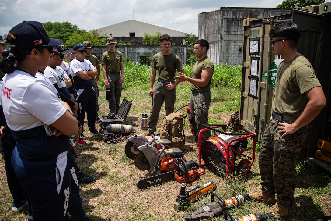 U.S. Marines assigned to Marine Wing Support Squadron (MWSS) 371, Marine Air Control Group 38, 3rd Marine Aircraft Wing, show Sailors from the Philippine Navy various types of equipment used for airfield operations during a subject matter expert exchange for Marine Aviation Support Activity 24 at Clark Air Base, Luzon, Philippines, June 6, 2024. MASA is an annual Philippine-U.S. military exercise focused on mutual defense, strengthening relationships, and rehearsing emerging aviation concepts. (U.S. Marine Corps photo by Cpl. Nikolas Mascroft)