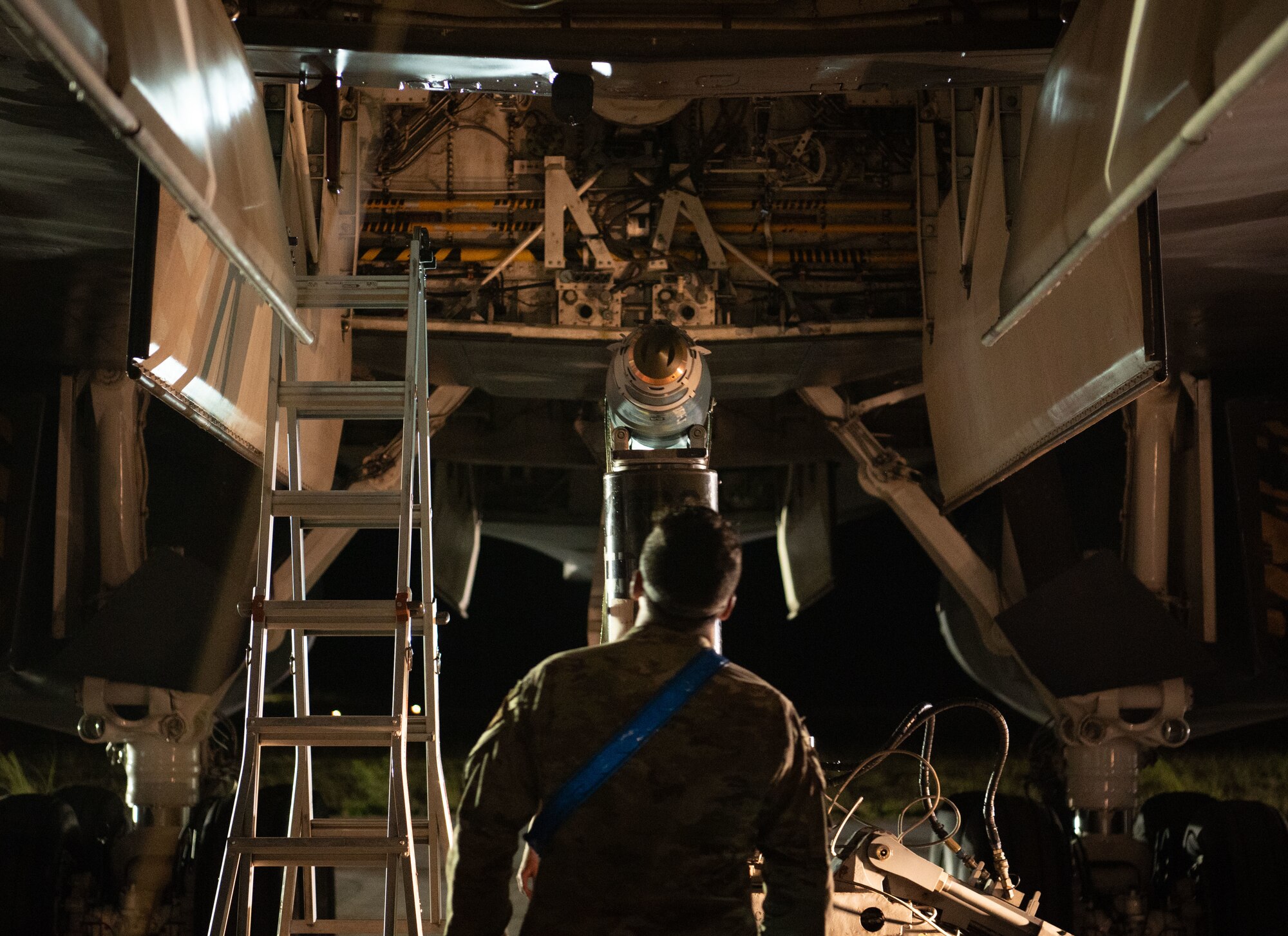 U.S. Air Force Senior Airman Joseph Cox, 28th Aircraft Maintenance Squadron load crew team chief watches a joint direct attack munition GBU-38 be placed onto a B-1B Lancer at Andersen Air Force Base, Guam, June 4, 2024, in support of a Bomber Task Force mission. U.S. Indo-Pacific Command forces routinely and visibly demonstrate commitment to our Allies and partners through the employment of our military forces, demonstrating strategic predictability, while becoming more operationally unpredictable to adversaries. (U.S. Air Force photo by Airman 1st Class Audree Campbell)