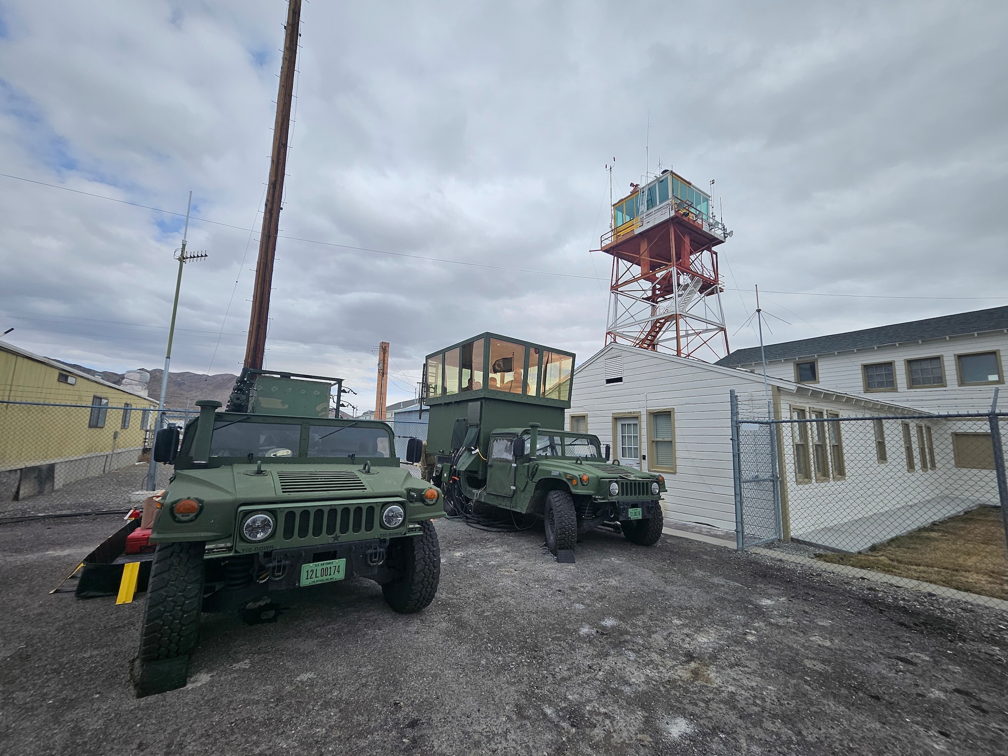 A mobile air traffic control tower sits below a World War II tower facility.