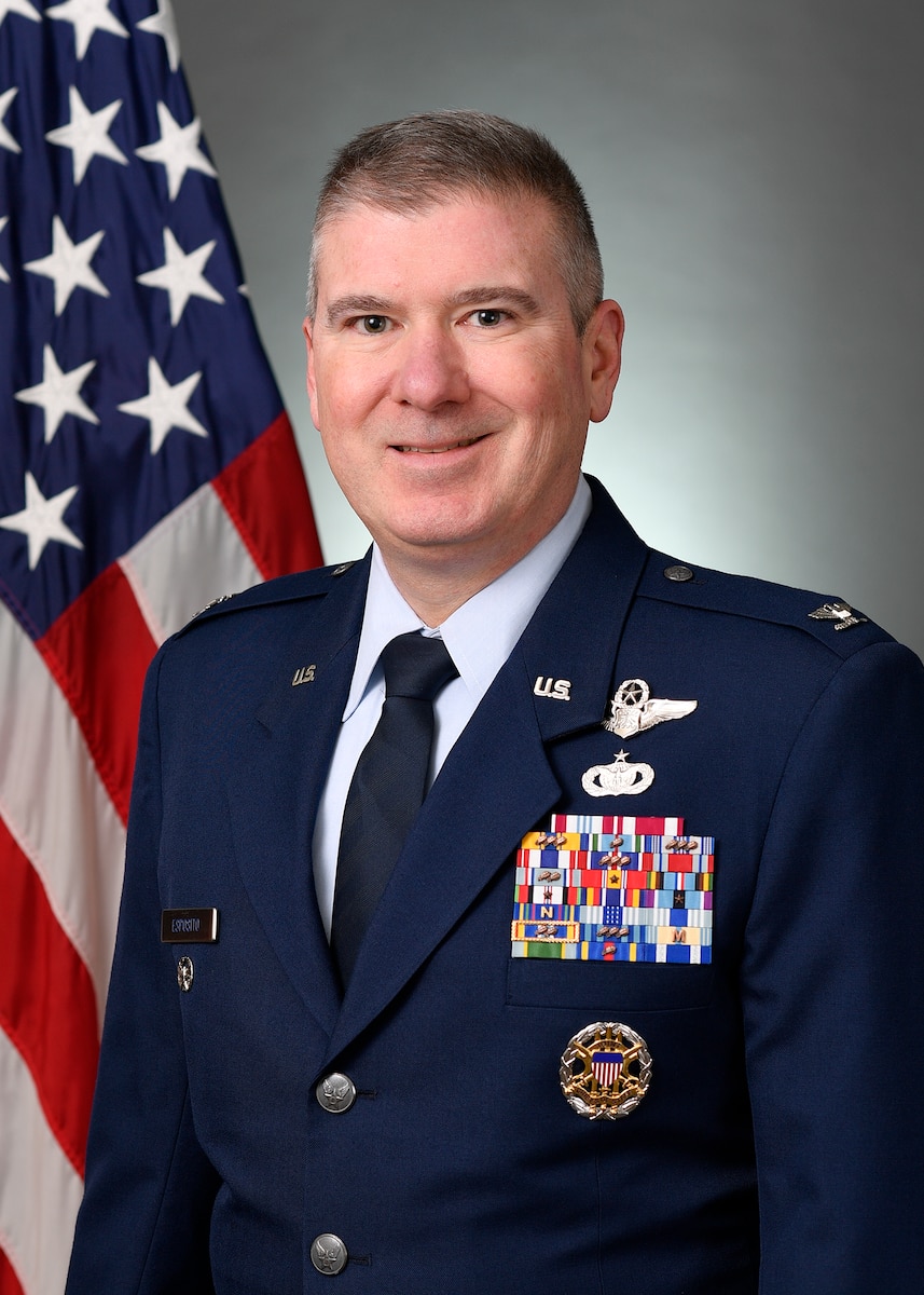 Official photo of Colonel Esposito with a US flag behind his shoulder