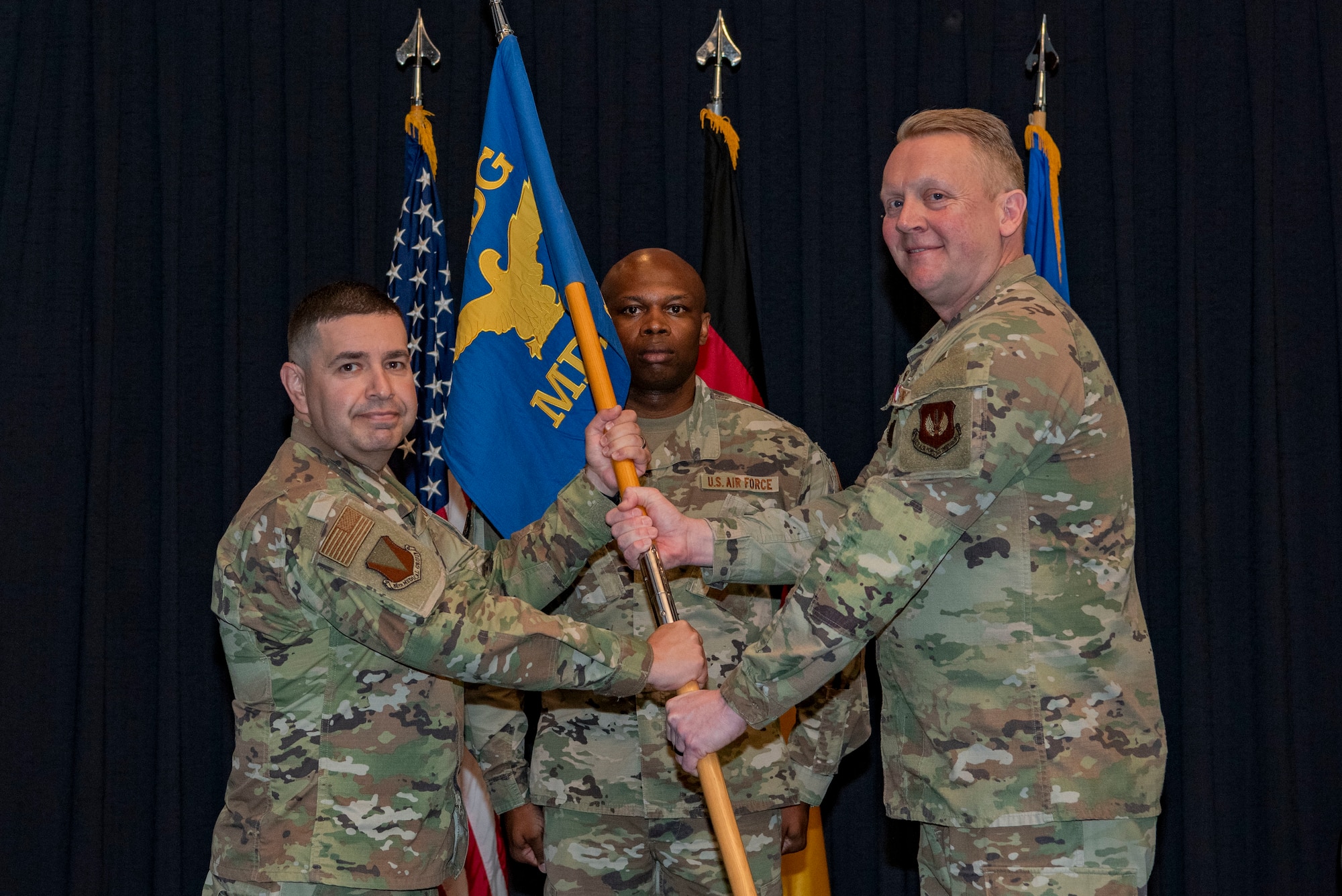 Men hold guidon