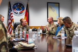 People sit around table during a briefing