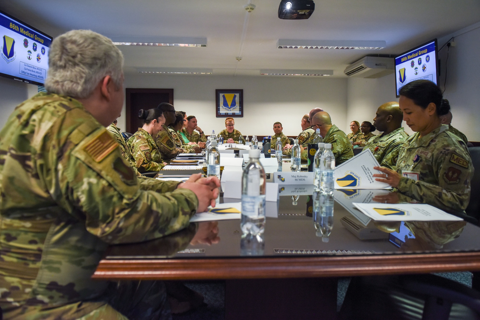 People sit around table for a briefing
