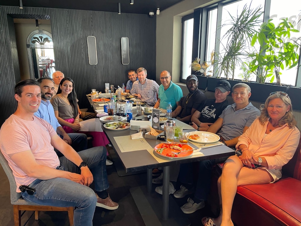 A group of people eating a meal around a table.