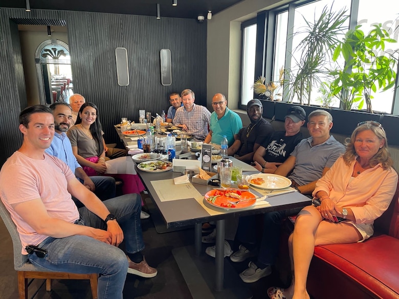 A group of people eating a meal around a table.