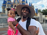 U.S. Army Staff. Sgt. Derrick Thompson and his one-year-old daughter are with friends and family at Disney’s Magic Kingdom