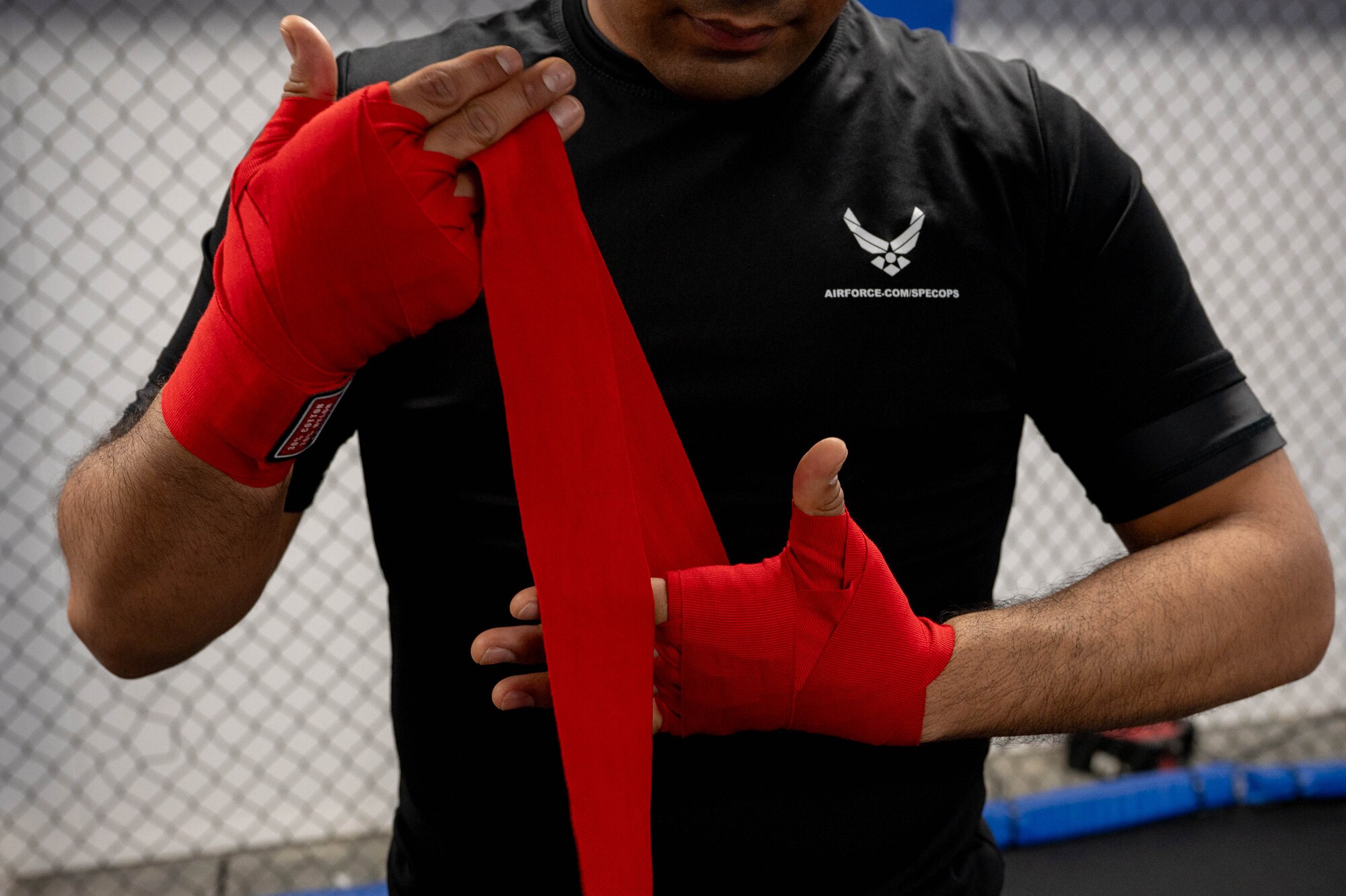 48th Security Forces Airman pre-wraps his hands before a kickboxing warmup