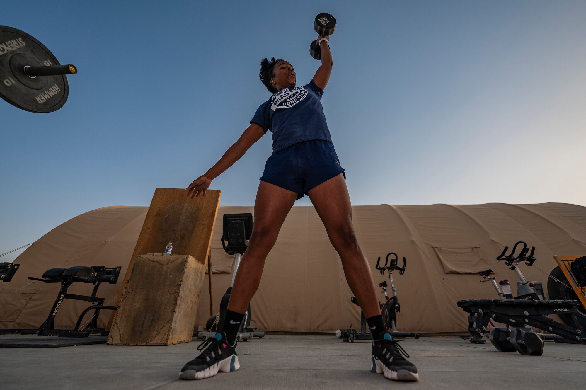 A U.S. Air Force Airman assigned to the 378th Air Expeditionary Wing participates in a CrossFit workout at an undisclosed location within the U.S. Central Command area of responsibility, June 22, 2024. By building interpersonal relationships, the CrossFit workout group has created an environment and culture of community through competition. (U.S. Air Force photo)