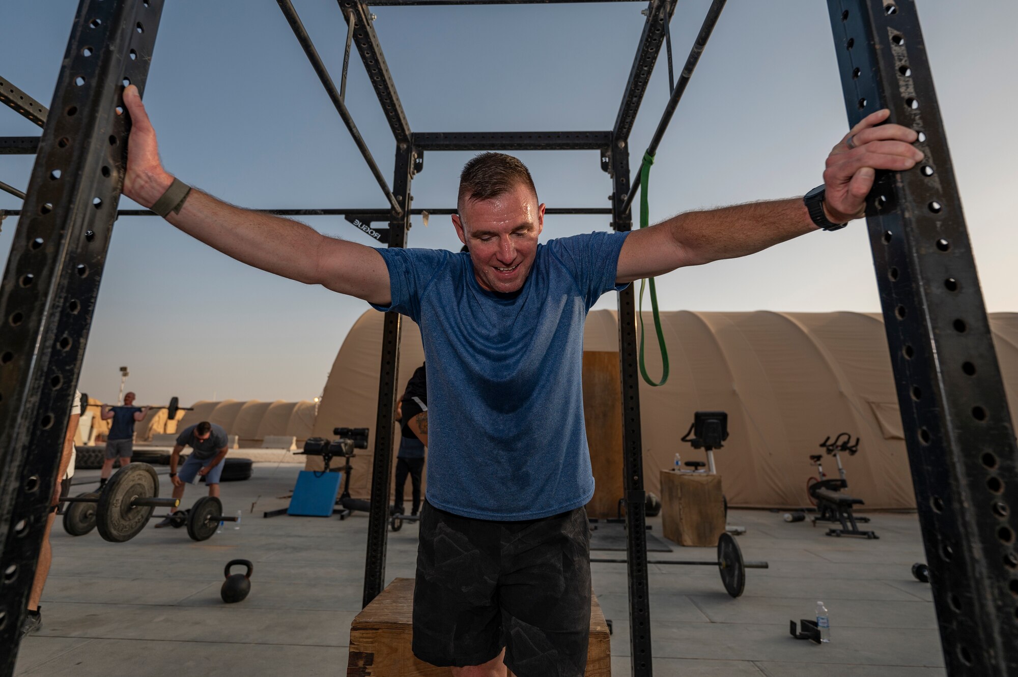The U.S. Air Force 378th Expeditionary Logistics Readiness Squadron commander participates in a CrossFit workout at an undisclosed location within the U.S. Central Command area of responsibility, June 22, 2024. Working out together enhances communication and community by pushing others to improve. (U.S. Air Force photo)