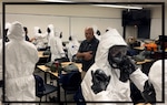 Coast Guard academy graduates don personal protective equipment (PPE) during Countering Weapons of Mass Destruction (CWMD) training (U.S. Coast Guard photo courtesy of Brock Gross).