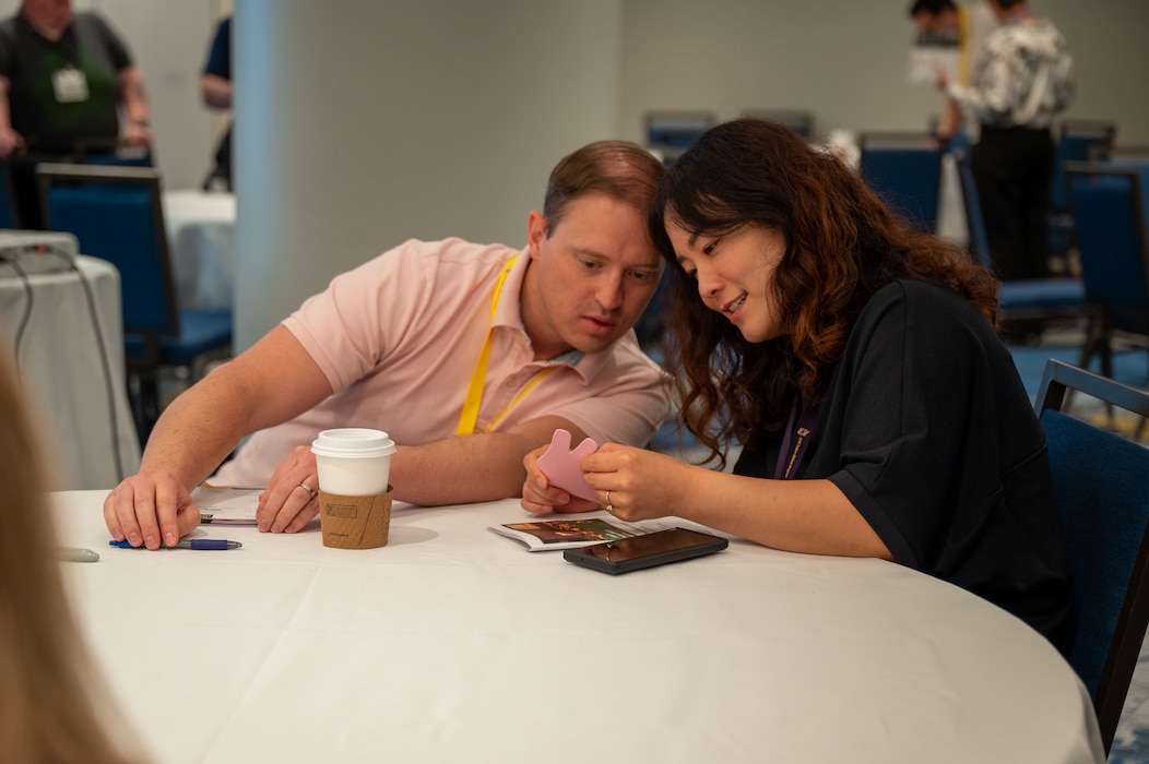 Photo of couple looking at a piece of paper