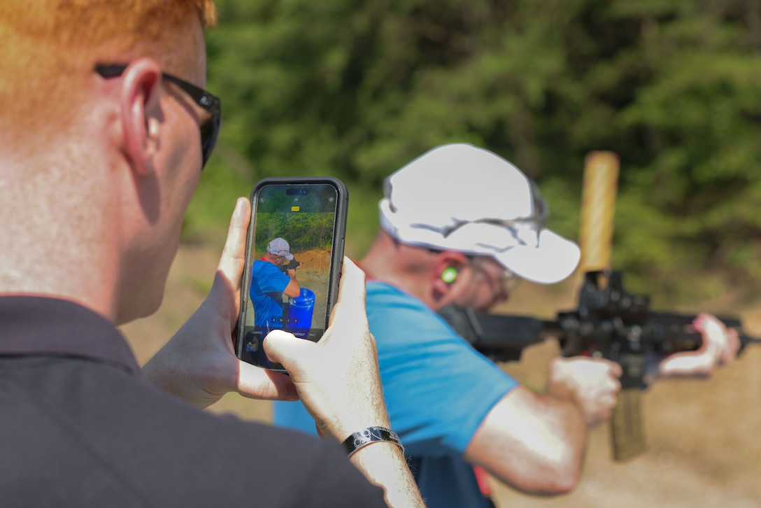 Brandon Gash, director for career planning and development at Drury University in Springfield, Mo., shoots the M27 Infantry Automatic Rifle during the Educators Workshop on Marine Corps Base Quantico Va., June 13, 2024.  The workshop enables MCRC to spread awareness of the Marine Corps' purpose, values and service opportunities to those educators who are engaged in supporting the future of their students. (U.S. Marine Corps photo by Lance Cpl. Brenna Ritchie)