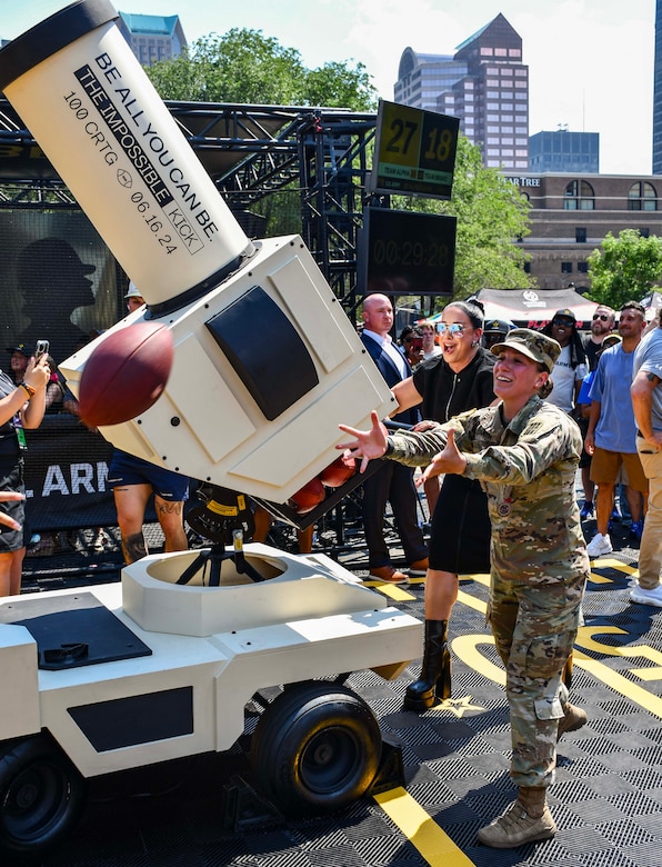 Army Soldier prepares to catch a football.