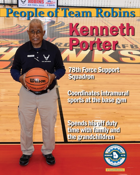 Man standing while holding a basketball, looking at the camera