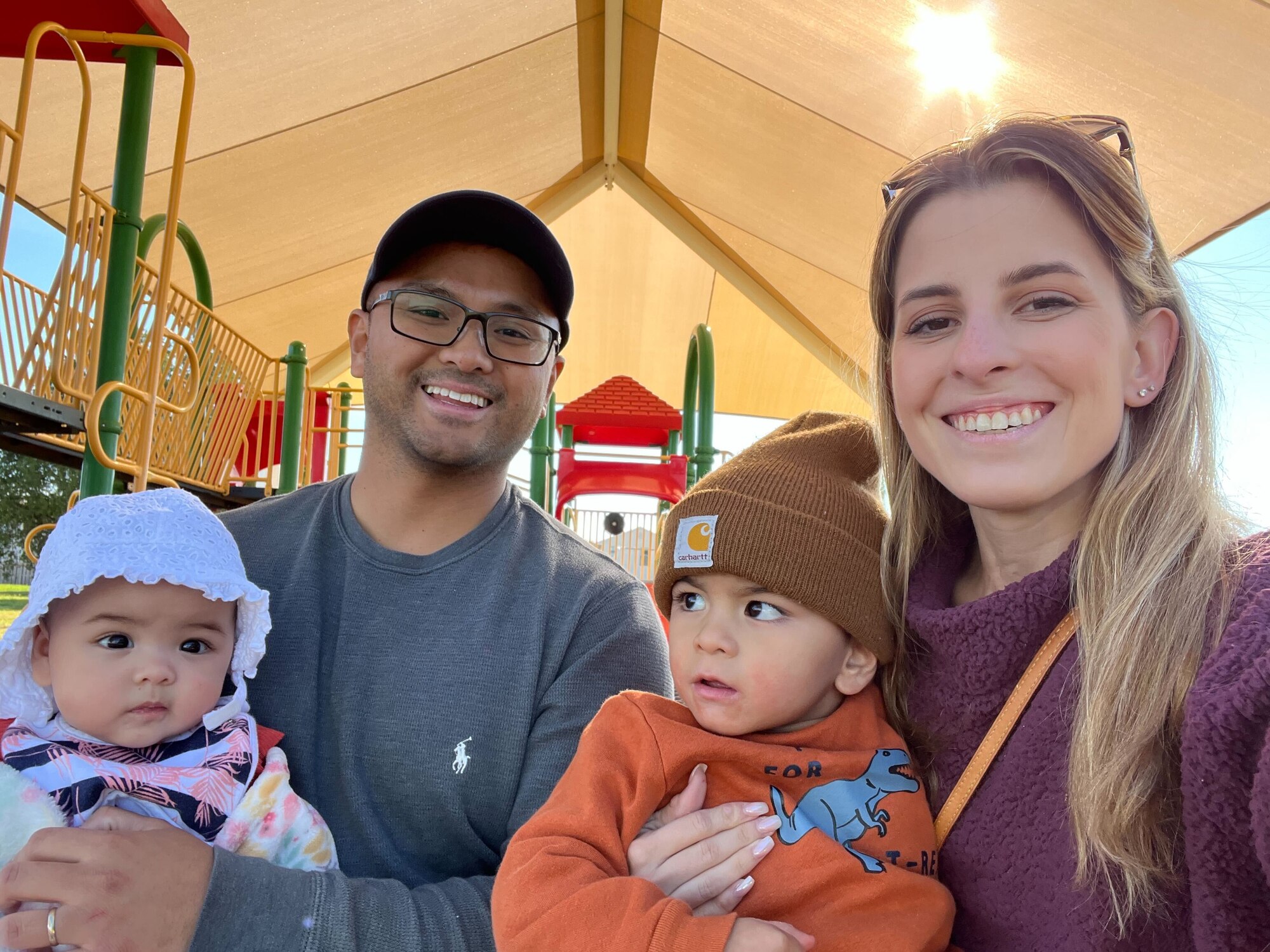 U.S. Air Force Senior Airman Brent Caronongan, 97th Force Support Squadron food services a.m. shift leader, poses for a picture with his wife, Allison, and two children at Sheppard Air Force Base, Texas, November 2023. Caronongan was at a park spending time with his family. (courtesy photo)