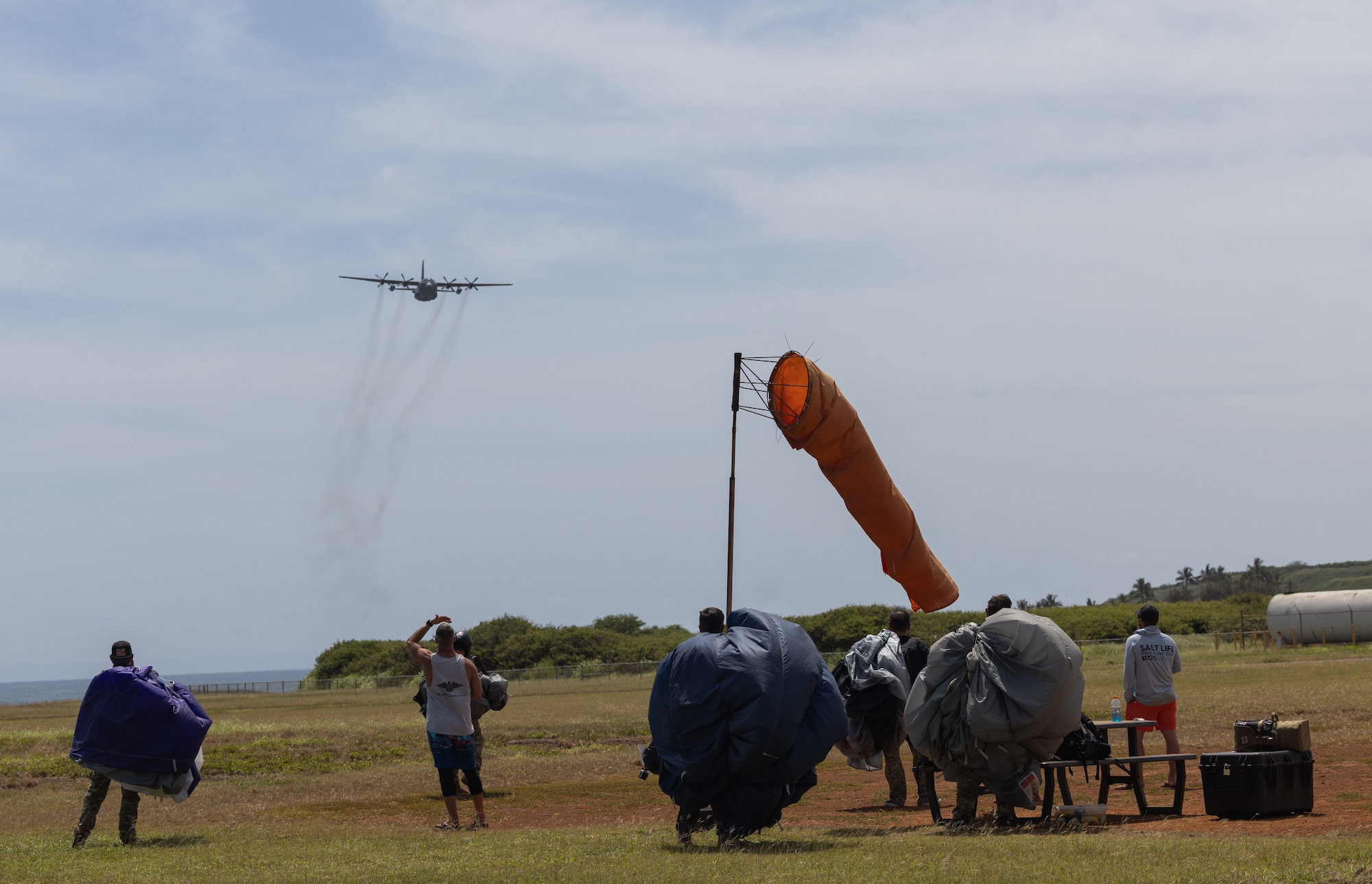 Members of the Special Warfare division assigned to the Air National Guard Air Force Reserve Command Test Center (AATC) prepare for a flyover from an AATC C-130 Hercules shortly after touching down on a remote landing zone in Kauai, Hawaii during Sentry Aloha 24-2.