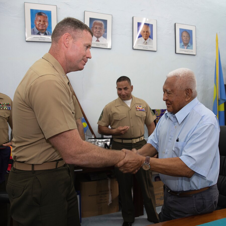 U.S. Marine Corps Col. Matthew Mulvey, left, commanding officer of Combat Logistics Regiment 17, 1st Marine Logistics Group, presents a challenge coin to Chief Reklai Raphael Ngirmang, Palau’s paramount high chief, and a retired U.S. Marine Corps Vietnam War veteran during exercise Valiant Shield 24 at Koror, Palau, June 17, 2024. Marine Corps leaders participating in Valiant Shield 24 met with Ngirmang on the final day of the exercise to express gratitude for Palau’s support and hospitality.  (U.S. Marine Corps photo by Sgt. Nello Miele)
