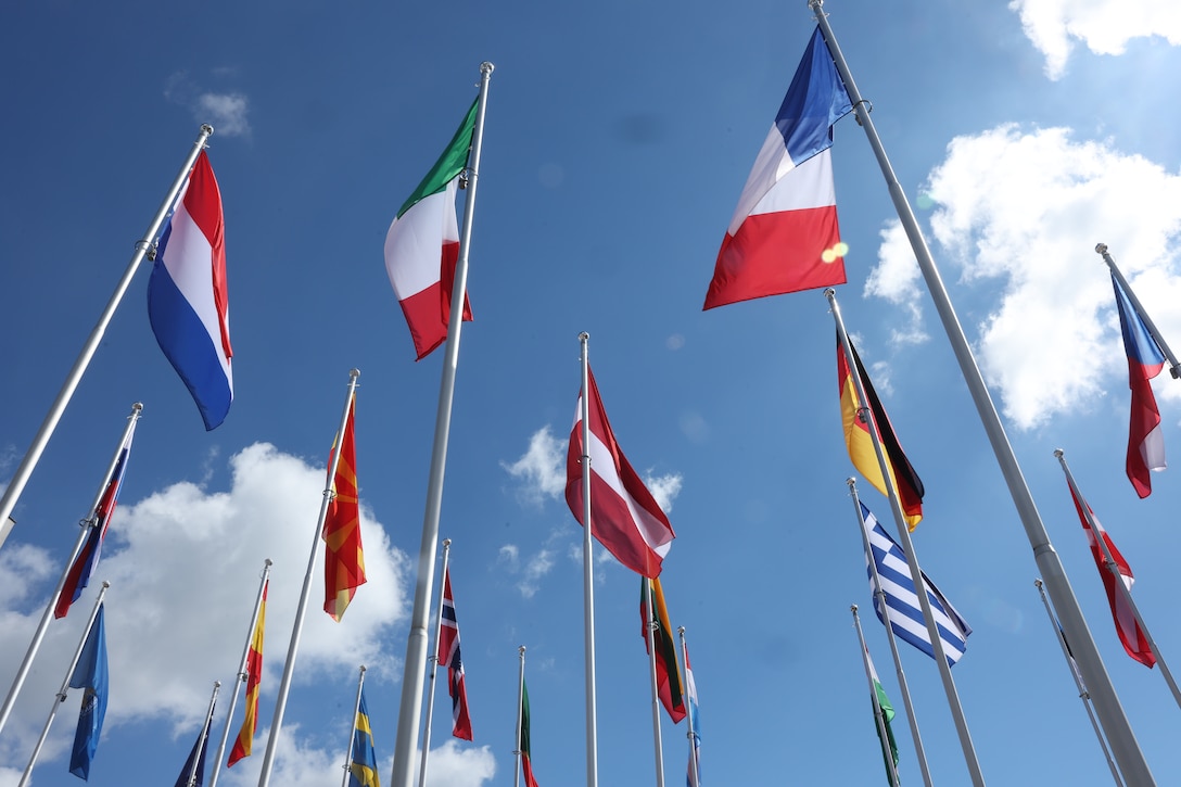 Armed service members from multiple nations gather for the closing ceremony of the Coalition Warrior Interoperability Exploration, Experimentation, Examination Exercise (CWIX24) at the Joint Force Training Centre in Bydgoszcz, Poland, June 20, 2024. CWIX enhances Command and Control (C2) capabilities for a modern and forward-looking military force. By focusing on digital transformation, multi-domain operations, and the digital backbone, CWIX ensures the interoperability of these critical components. The exercise involves multiple countries, fostering international cooperation and technological integration. (U.S. Marine Corps photo by Lance Cpl. Garrett Gillespie)