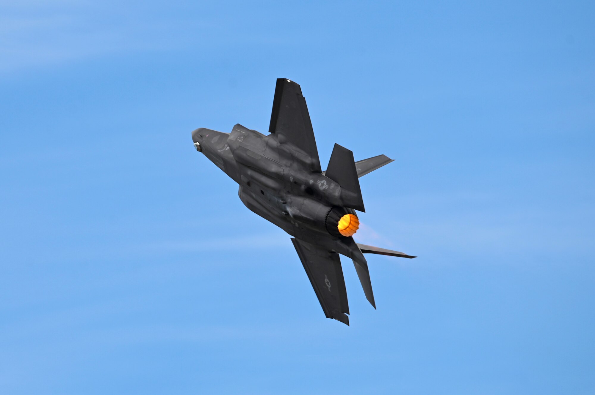 An F-35 aircraft flies in the sky.