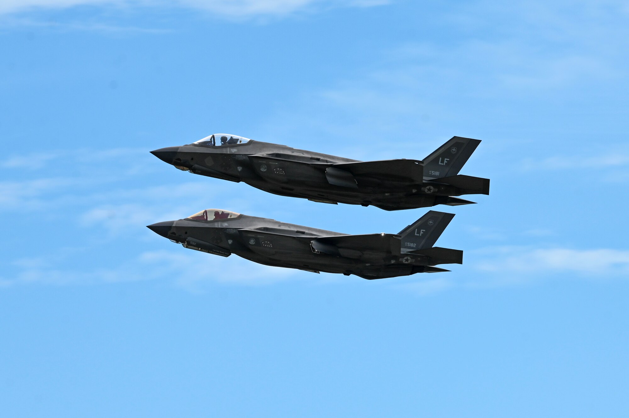 Two F-35 aircrafts fly in the sky.