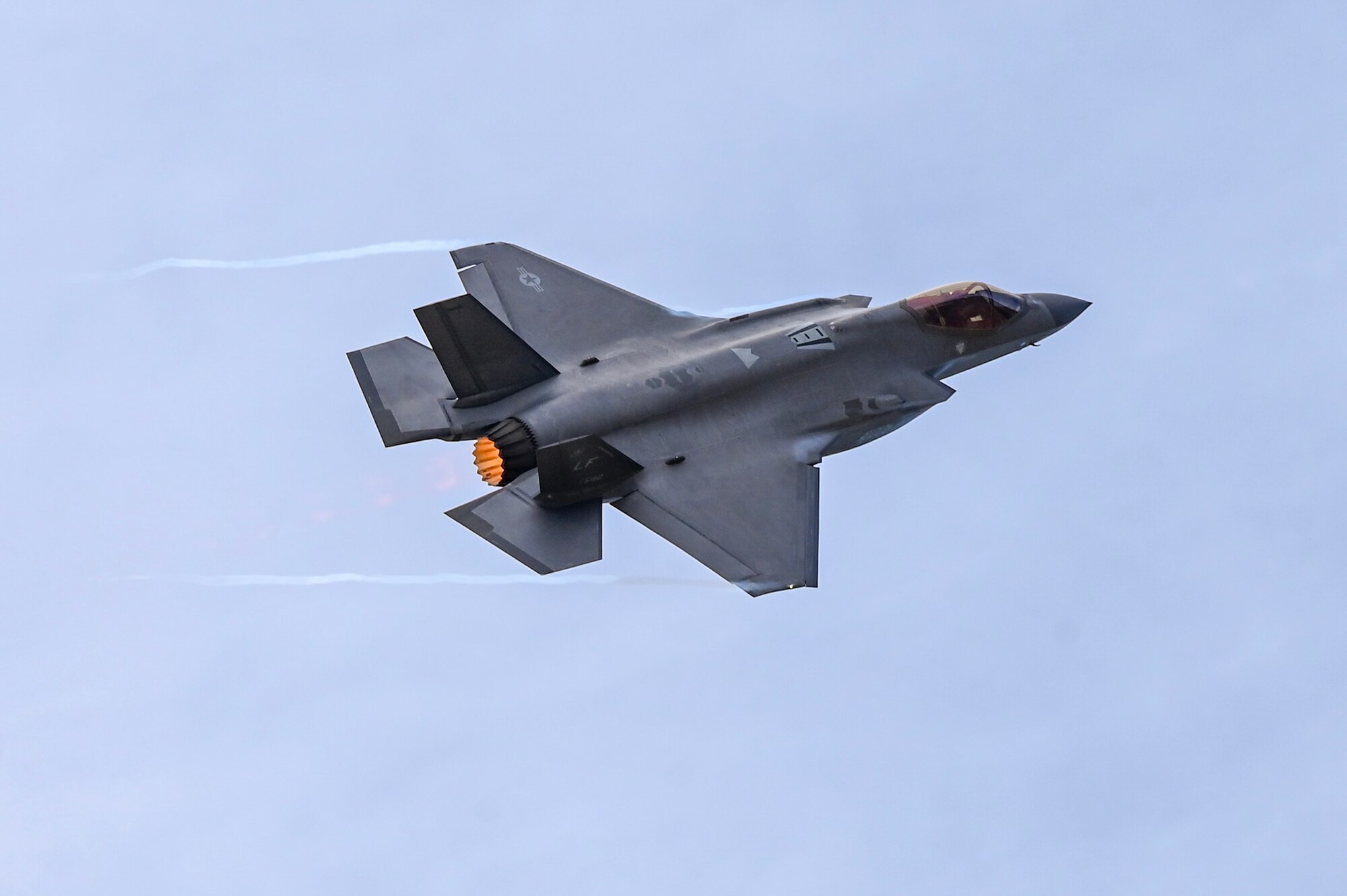 An F-35 flies in the sky.