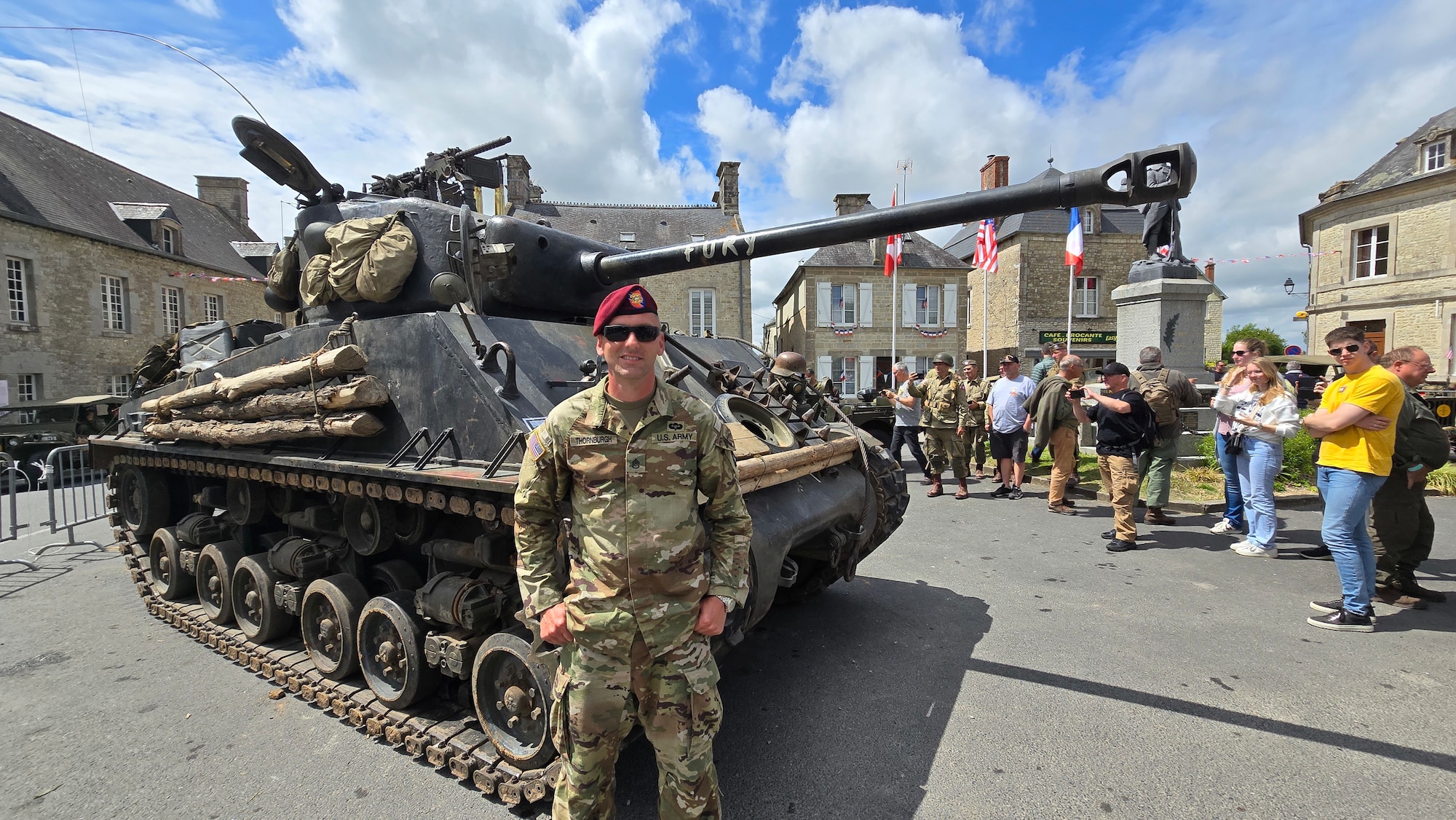 Keith Thornburgh, photographer at Arnold Air Force Base, headquarters of Arnold Engineering Development Complex, poses in front of WWII era Army tank during his trip to Normandy, France, June 4, 2024, where he took part in the 80th anniversary of D-Day. (U.S. Air Force Photo by Keith Thornburgh)