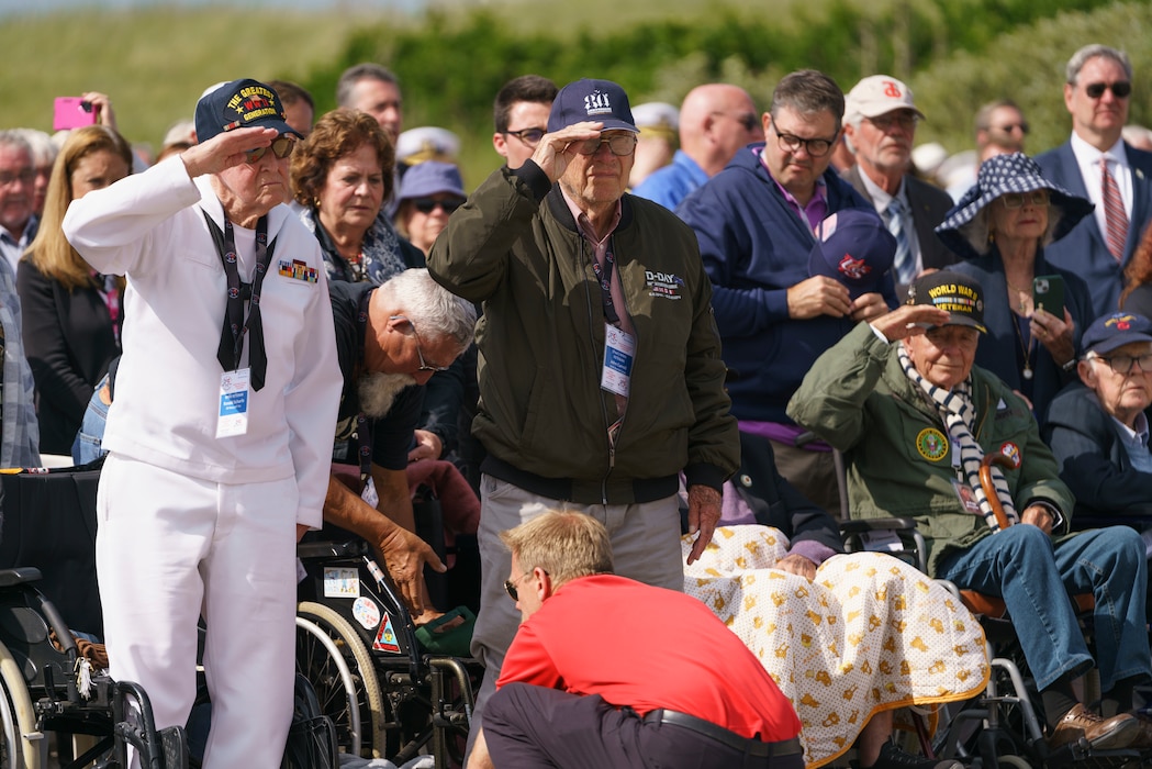 U.S. WWII veterans stand and salute during the playing of the National Anthem at the Utah Beach D-Day Ceremony at Utah Beach, Normandy, France, June 6, 2024. The U.S. Army and members from European allied nations are participating in the 80th anniversary of Operation Overlord, supporting local events across Normandy, from June 1- 10, 2024 to commemorate the selfless actions by all the allies on D-Day that continue to resonate 80 years later. (U.S. Army photo by Staff Sgt. Keith Thornburgh)