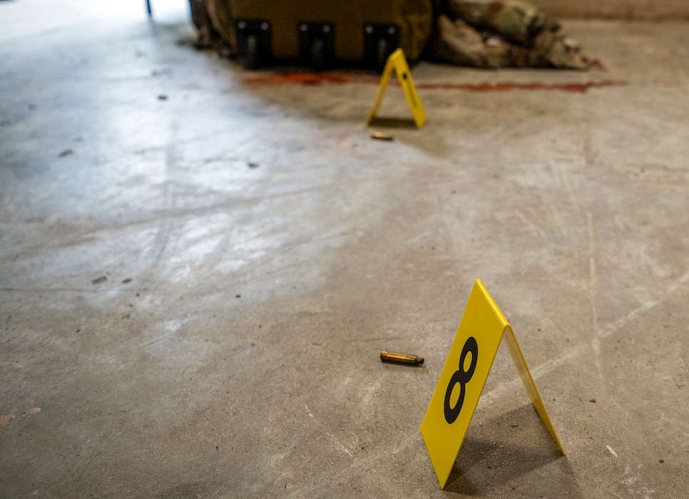 Evidence identification markers stand next to ammunition casings at Moody Air Force Base, Georgia, June 20, 2024. Federal agents from the Office of Special Investigations Detachment 211 processed the simulated scene of an active shooter incident. The goal of the exercise was to assess and improve base personnel and security forces’ actions and response to an active shooter incident. (U.S. Air Force photo by Airman 1st Class Leonid Soubbotine)