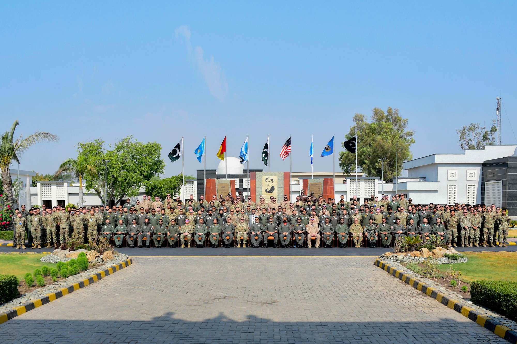 U.S. Air Force Airmen assigned to the U.S. Central Command area of responsibility stand with members of the Pakistan Air force for a group photo in an undisclosed location in Pakistan after the opening ceremony of Exercise Falcon Talon, June 1, 2024.