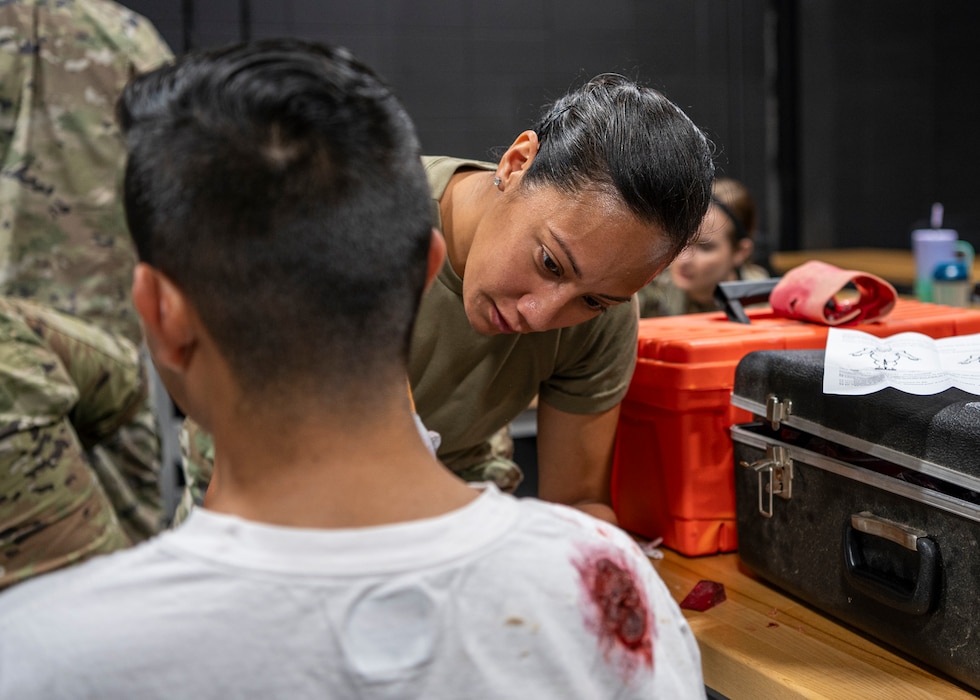 U.S. Air Force Tech. Sgt. Andrea Miles, 23rd Medical Group ambulance response noncommissioned officer in charge, applies moulage makeup at Moody Air Force Base, Georgia, June 20, 2024. Moulage was applied to simulate gunshot wounds on the victims of an active shooter exercise. The goal of the exercise was to assess and improve base personnel and security forces’ actions and response to an active shooter incident. (U.S. Air Force photo by Airman 1st Class Leonid Soubbotine)