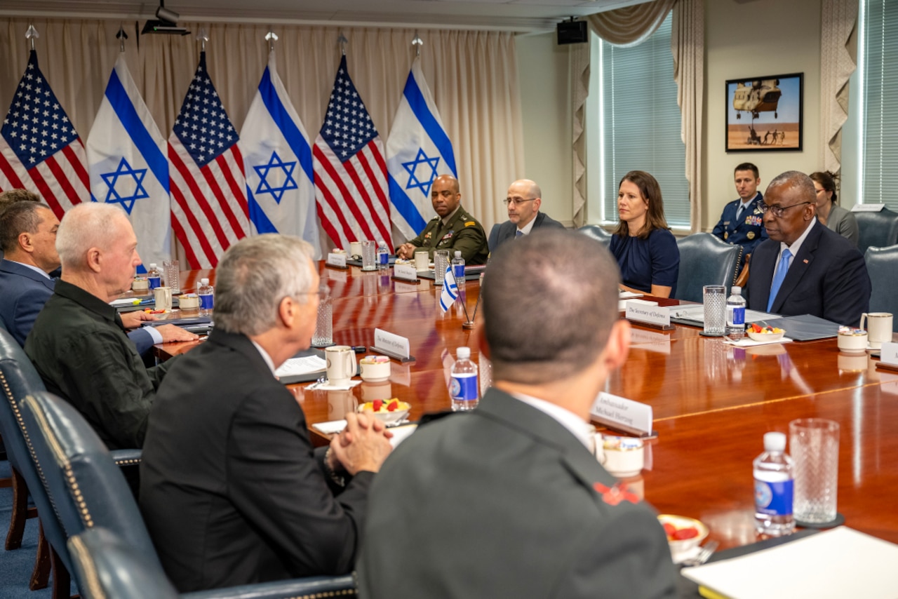 Men and women sit around a table.