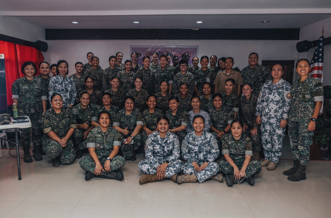 U.S. Marines with I Marine Expeditionary Force (Forward) and Marine Aircraft Group 13, 3rd Marine Aircraft Wing, and service members with the Philippine Navy and Marine Corps, pose for a photo during a women's leadership symposium during Marine Aviation Support Activity 24 at Fort Bonifacio, Manila, Philippines, June 14, 2024. This was the first time a women's leadership conference was conducted in the Philippines, and focused on developing individual leadership, resilience, and strong bonds by presenting discussions on work-life balance, talent management, and building a stronger community. MASA is an annual Philippine-U.S. military exercise focused on mutual defense, strengthening relationships, and rehearsing emerging aviation concepts. (U.S. Marine Corps photo by Sgt. Shaina Jupiter)