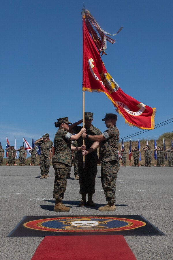 U.S. Marine Corps Lt. Col. Mabel B. Annunziata, left, oncoming commanding officer of 1st Radio Battalion, I Marine Expeditionary Force Information Group, receives the guidon from Lt. Col. Curtis A. Williamson, outgoing commanding officer of 1st Radio Bn, I MIG, during a change of command ceremony at Marine Corps Base Camp Pendleton, California, June 24, 2024. The change of command ceremony was held to commemorate the passing of command from Williamson to Annunziata. Williamson is a native of Texas and Annunziata is a Florida native. (U.S. Marine Corps photo by Lance Cpl. Nicole Stuart)