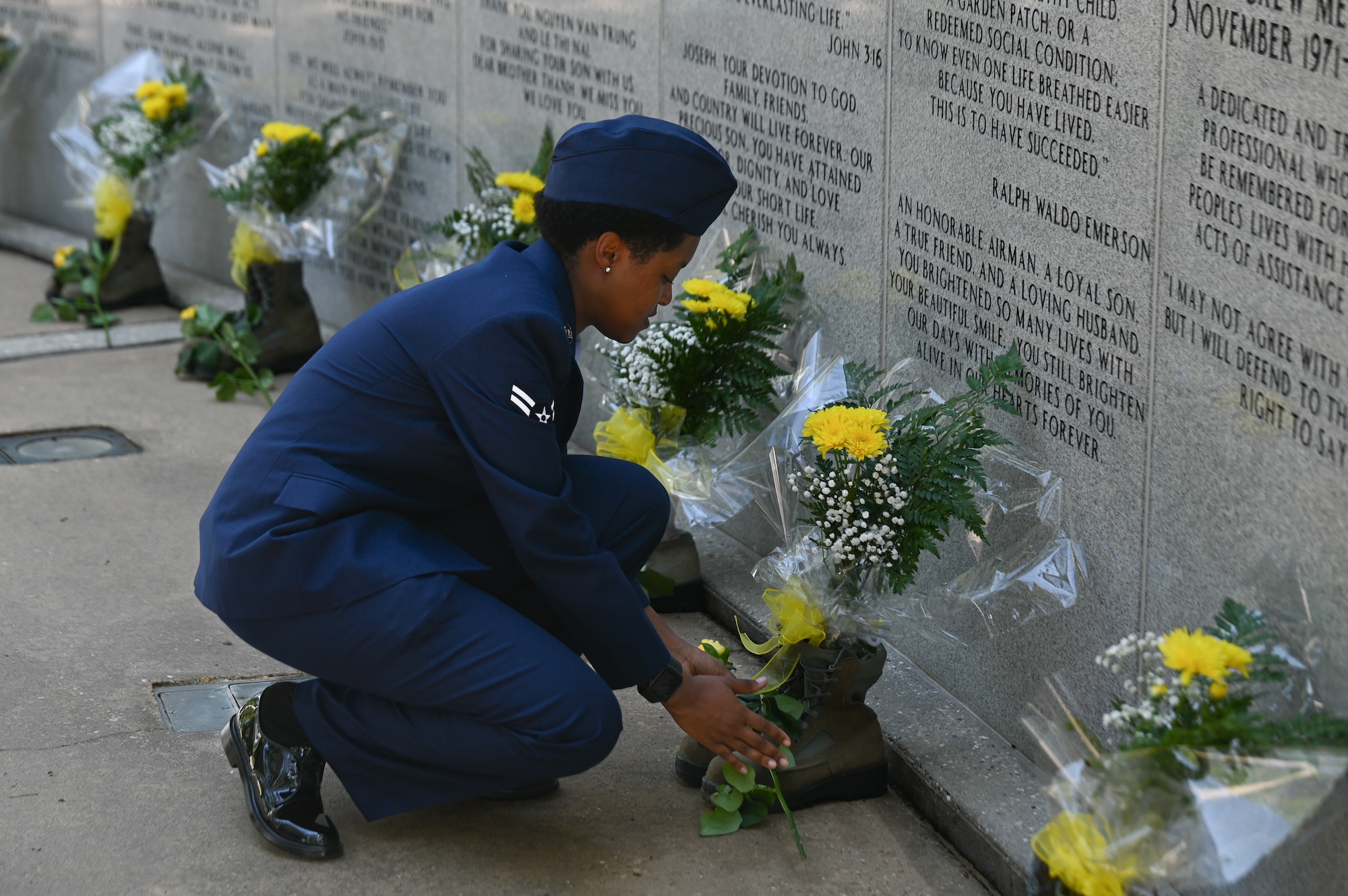 U.S. Air Force Airman 1st Class Bobbie Mills, 60th Fighter Squadron aircrew flight equipment apprentice, places a rose to honor a fallen airman during the Khobar Towers memorial ceremony at Eglin Air Force Base, Florida, June 25, 2024.