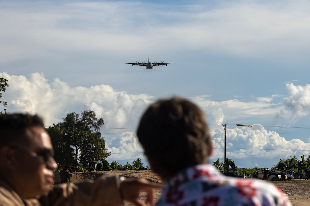 U.S. Marines and Sailors with Marine Corps Engineer Detachment Palau 24.1, and locals of Peleliu, observe a U.S. Marine Corps KC-130J Super Hercules aircraft with 1st Marine Air Wing, land on a newly designated airstrip on the island of Peleliu, Republic of Palau, June 22, 2024. For the first time since its recertification in June, a military fixed-wing aircraft has touched down on the historic Peleliu airstrip, marking a significant and triumphant return to this iconic World War II site. (U.S. Marine Corps photo by Lance Cpl. Hannah Hollerud)
