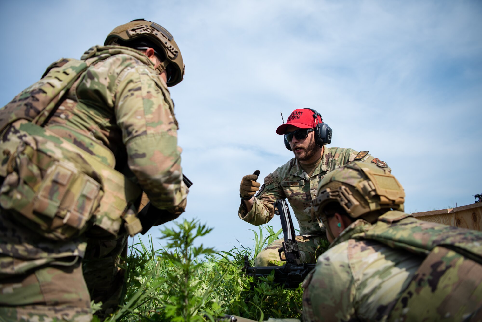 U.S. Air Force Senior Airman Justin Woods, 35th Security Forces Squadron (SFS) combat arms instructor, explains how to reload the M249 light machine gun to Airmen assigned to the 35th SFS during heavy weapons qualification at Draughon Range, near Misawa Air Base, Japan, June 18, 2024.