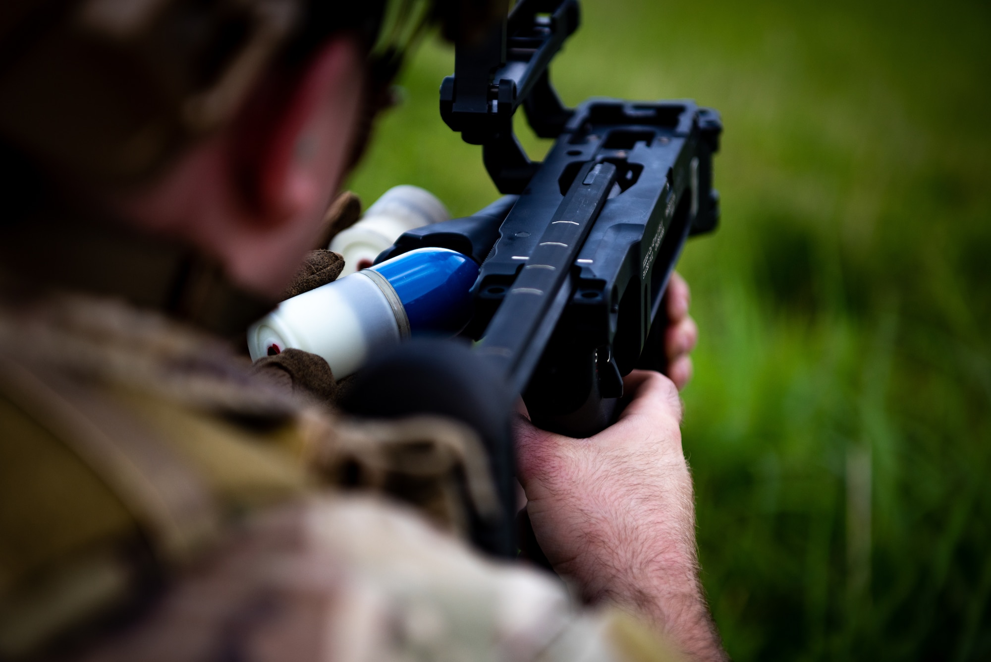 A U.S. Air Force 35th Civil Engineer Squadron Explosive Ordnance Disposal (EOD) member reloads the M320A1 grenade launcher for his wingman during heavy weapons qualification at Draughon Range, near Misawa Air Base, Japan, June 18, 2024.