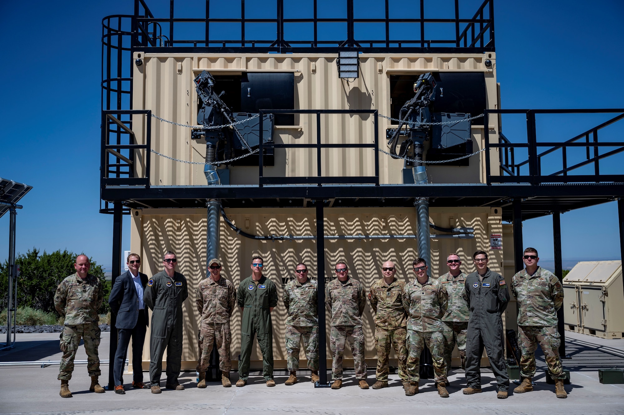 People pose for a photo in front of a training facility.