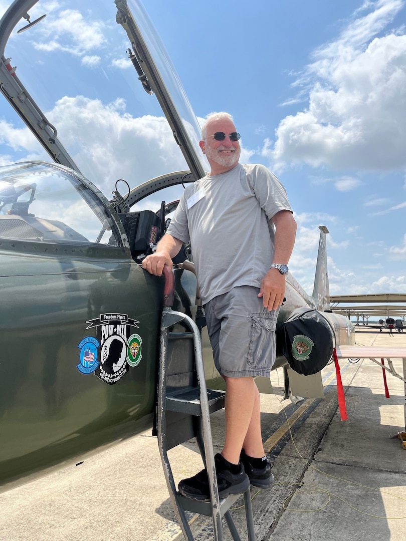 Photo of educator standing by aT-38