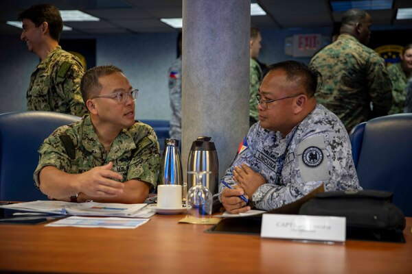 Capt. Tuan Nguyen, assigned to Commander, U.S. 7th Fleet, speaks with Philippine Navy Capt. Lued Lincuna, Chief of Fleet Staff, during U.S. – Philippines Staff Talks aboard the 7th Fleet flagship USS Blue Ridge (LCC 19) during a port visit to Manila, Philippines, June 20, 2024.