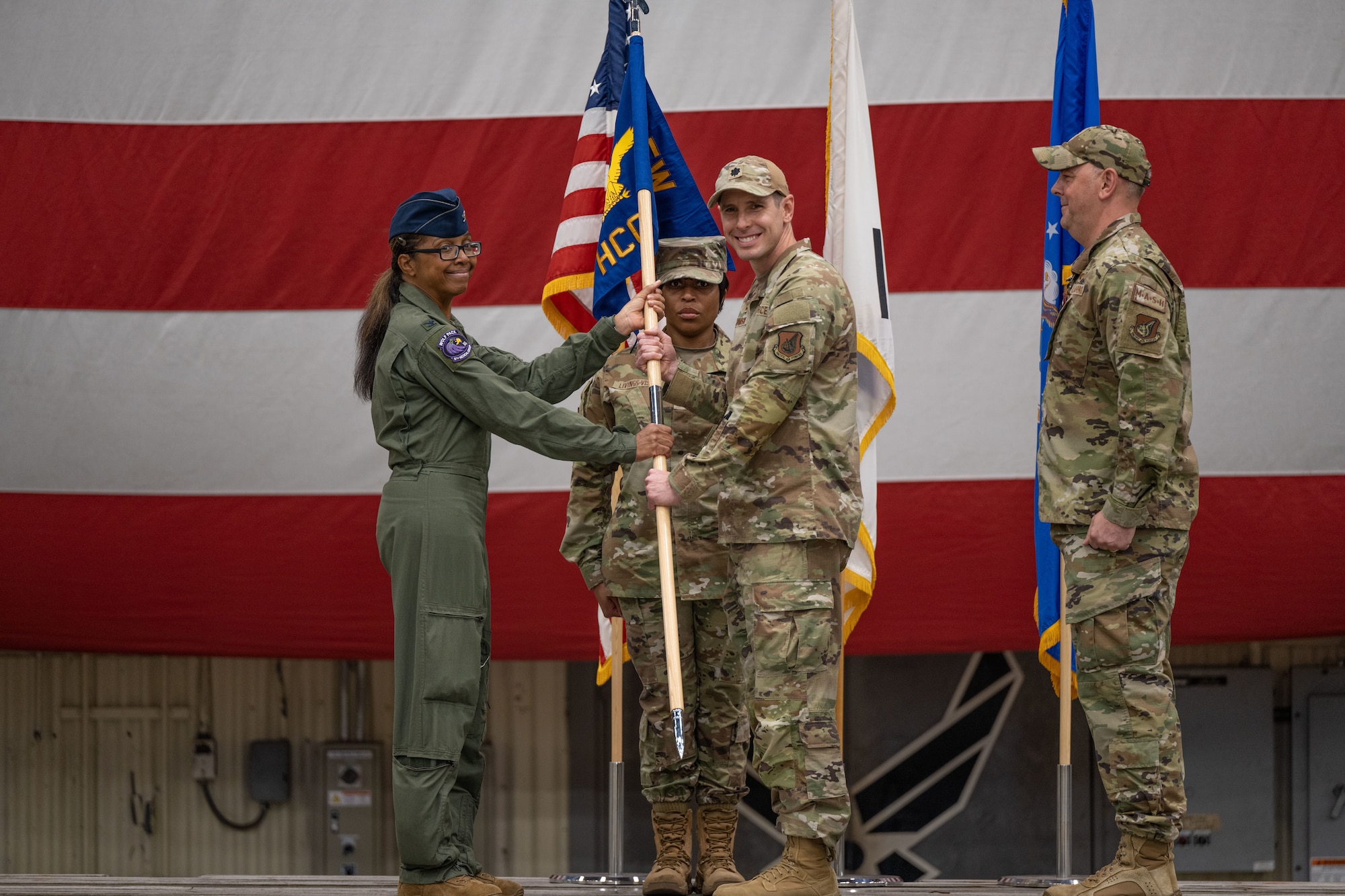 Lt. Col Brian Johnson, 8th Healthcare Operations Squadron incoming commander, receives the 8th HCOS guidon from Col. Elizabeth Anderson-Doze, 8th Medical Group commander, during the 8th HCOS change of command ceremony.