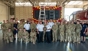 436th Civil Engineer Squadron fire department poses for a photo after receiving the Chief Master Sgt. Ralph E. Sanborn Fire Department of the Year Award for medium-sized department at Dover Air Force Base, Delaware, June 25, 2024. The fire department was recognized for its outstanding degree of excellence in base mission support and fire protection management. (U.S. Air Force photo by Senior Airman Amanda Jett)
