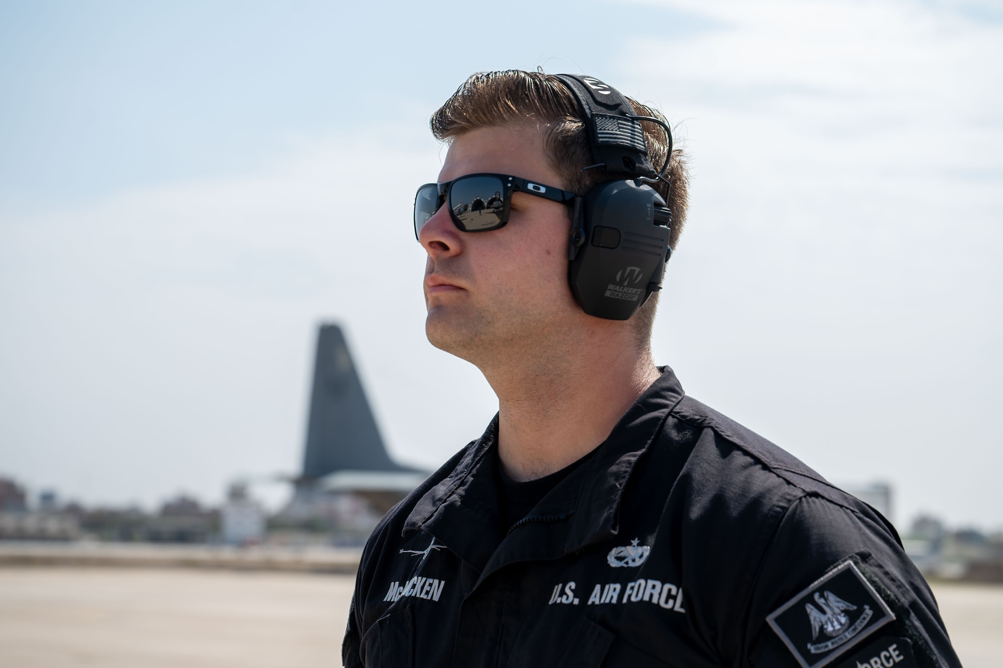 A close-up of an Airman looking off screen.