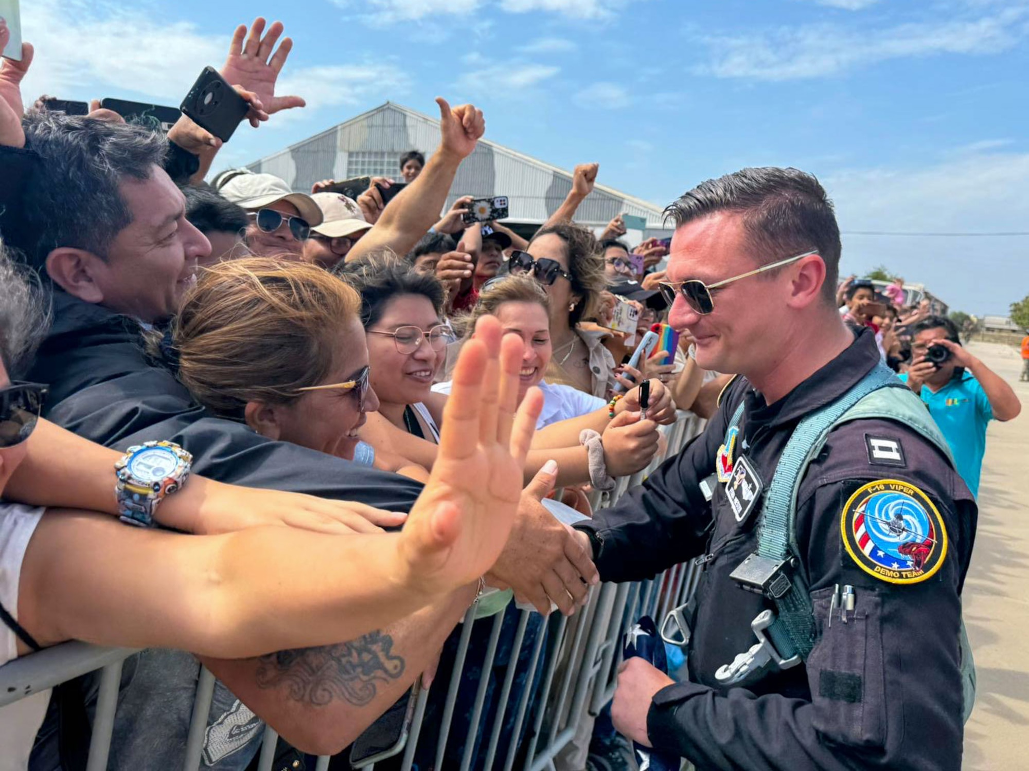 Captain Hiester shakes hands with a crowd of people.