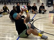 U.S. Army Spc. Janmiguel TorresCruz prepares to return a serve at sitting volleyball practice for Team Army during the 2024 Department of Defense Warrior Games