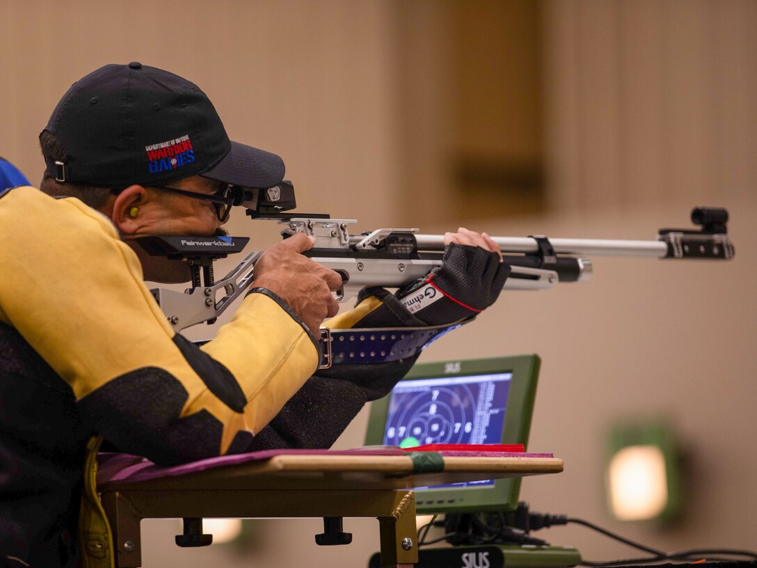 U.S. Army 1st Lt. Matthew Hovey shoots his air rifle at a target during the precision air event during the 2024 Department of Defense Warrior Games