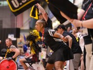 U.S. Army veteran Lavone Kendrick cheers for Team Army at a wheelchair ruby match during the 2024 Department of Defense Warrior Games