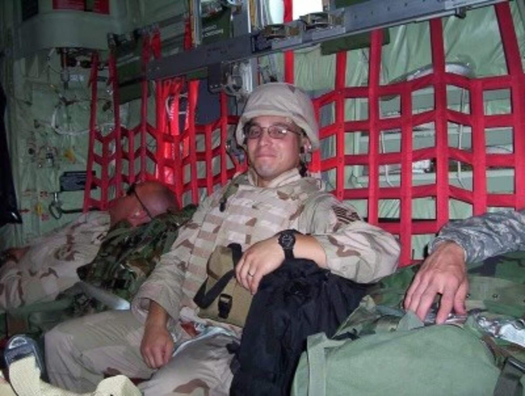A military service member on a plane.