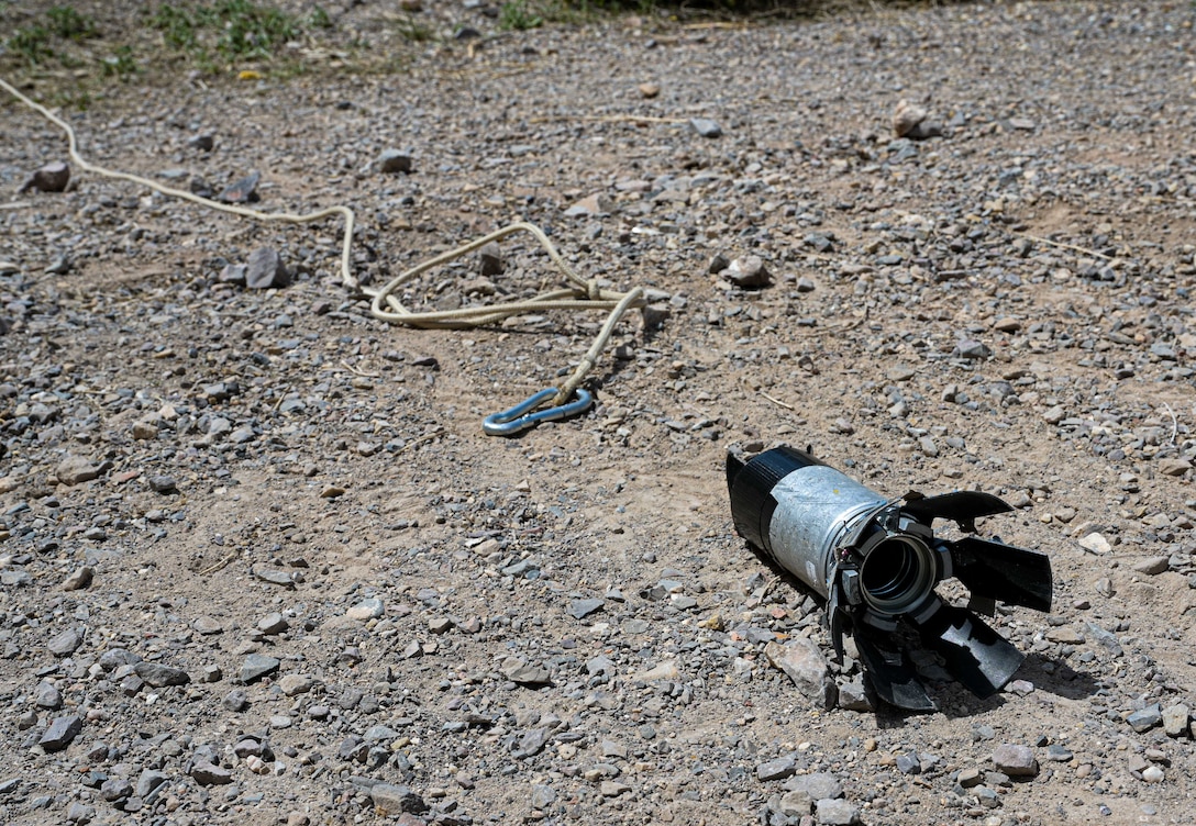 An explosive is next to a hook.